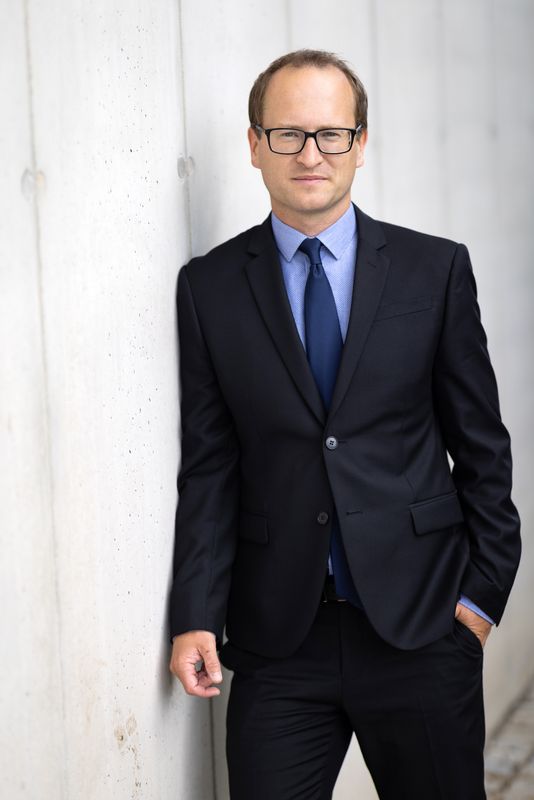 Tomas Havranek (Tomáš Havránek), leaning on a concrete wall, 2022